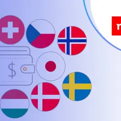 Jak założyć konto walutowe w mBank? Grafika przedstawia portfel z symbolem dolara otoczony flagami różnych krajów, sugerując międzynarodowe możliwości finansowe.