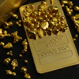 Złote samorodki i sztabka "FINE GOLD 9999 1 OUNCE TROY" - inspiracja, jak inwestować w złoto.
