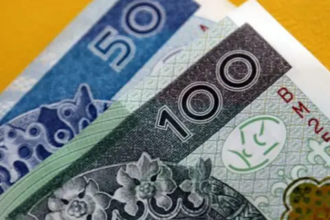 Złotówki na żółtym tle. Zastanawiasz się, jak spłacić kredyt odnawialny mBank? Te banknoty mogą pomóc!