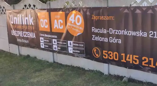 Baner reklamowy Unilink z informacją o ubezpieczeniach OC, AC, adresie i numerze telefonu w Zielonej Górze.