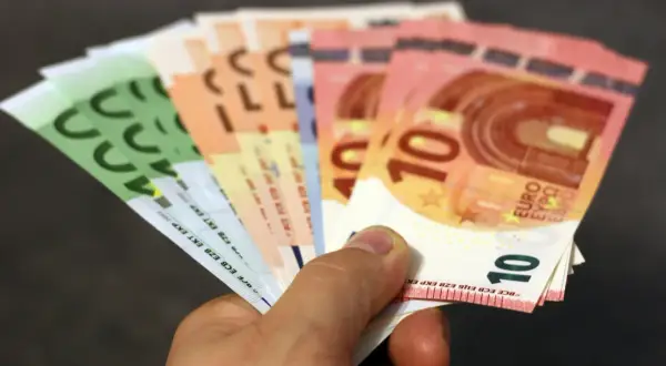 Dłoń trzyma banknoty euro. Choć w Bułgarii obowiązuje lew, euro jest powszechnie akceptowane w turystycznych miejscach.