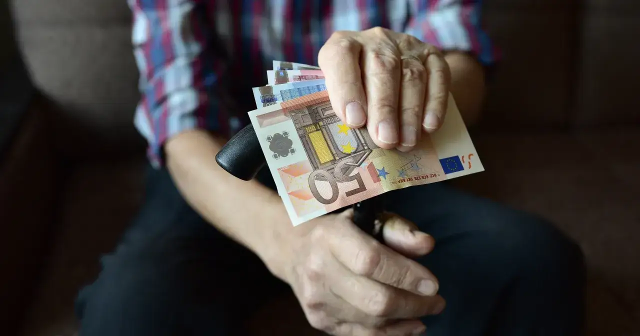 Stars on euro banknotes, a common sight in Slovakia, are held by an elderly person with a cane.