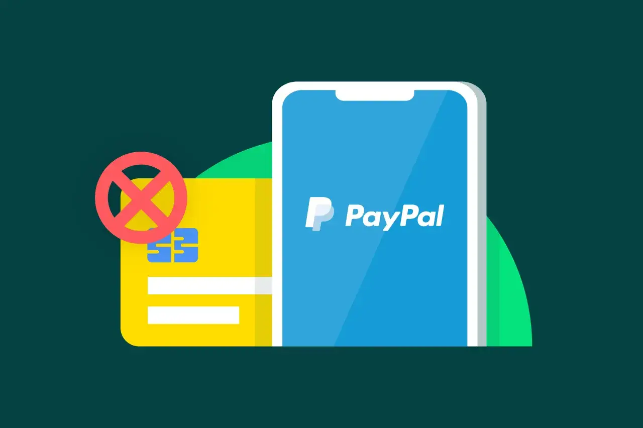Dowiedz się, jak przelać pieniądze na PayPal, gdy karta płatnicza jest niedostępna. Smartfon z logo PayPal i przekreślona karta.