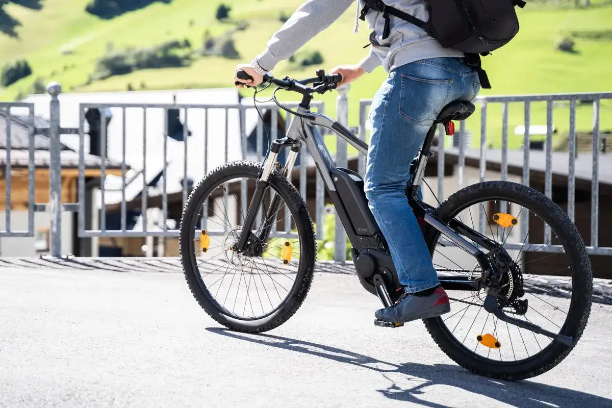 Osoba na rowerze elektrycznym, idealnym dla tych, którzy szukają ekologicznego transportu i chcą skorzystać z dofinansowania do roweru elektrycznego.