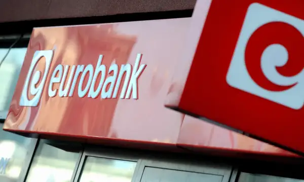 Logo eurobank na czerwonym tle. Obok widoczny fragment innego znaku, również z czerwonym elementem.