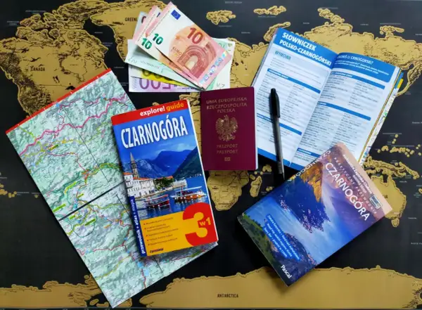 Mapa świata, euro, paszport, przewodnik i słowniczek po Czarnogórze.